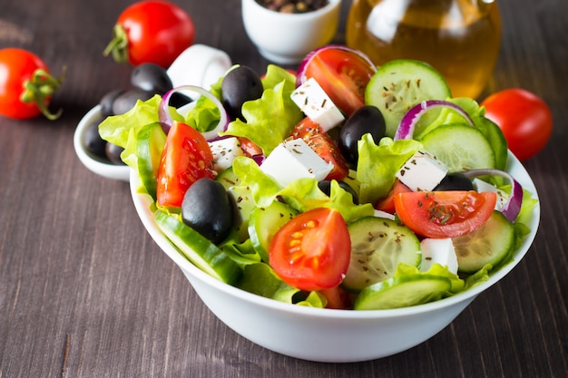 Fresh greek salad on wooden background. Premium Photo