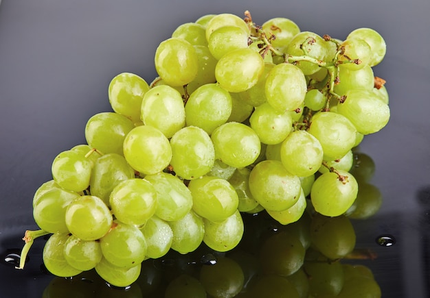 Premium Photo | Fresh green grapes with water drops on a gray background