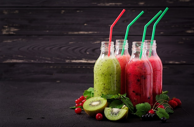 Fresh healthy smoothies from different berries on a dark background. diet menu. Premium Photo