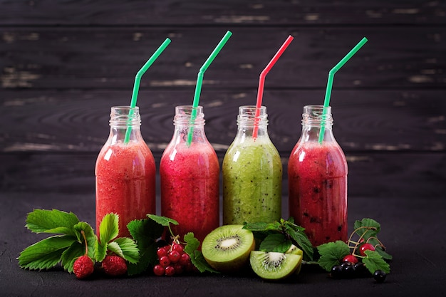Fresh healthy smoothies from different berries on a dark background. Diet menu. Premium Photo