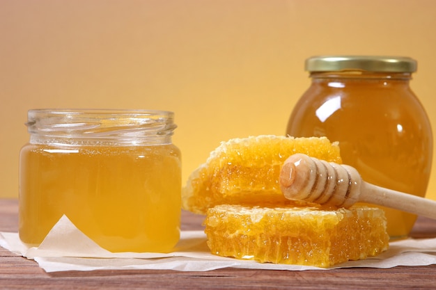 Premium Photo | Fresh honey on the table closeup on a colored background