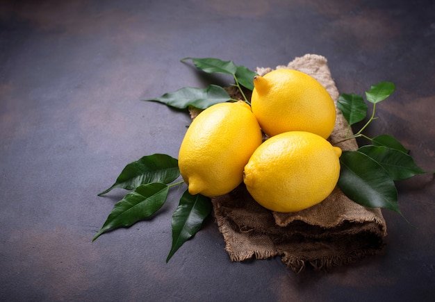 Fresh juicy lemons on rusty background Premium Photo