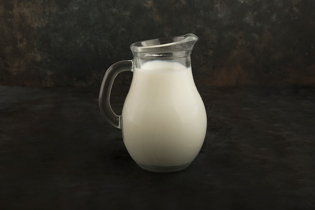 Fresh milk in a glass jar on black background | Free Photo