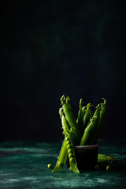 Premium Photo | Fresh pea pods on green background