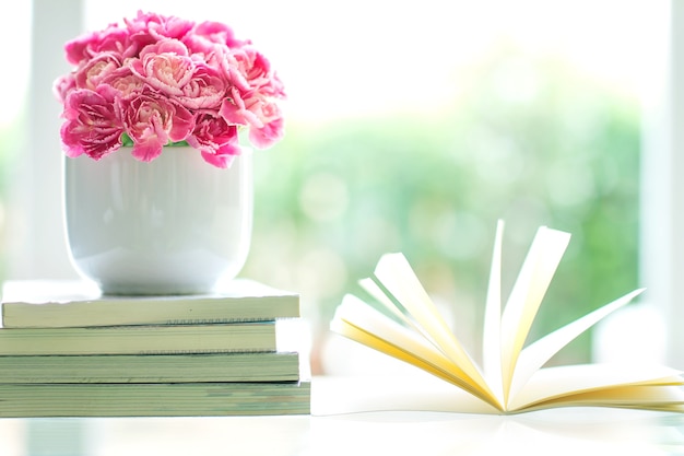 Premium Photo | Fresh pink carnation flower with books background