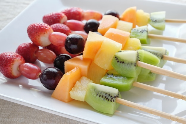 Premium Photo Fresh Rainbow Fruit Skewers On White Plate