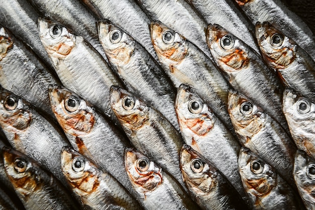 Premium Photo | Fresh raw fish anchovy and sprat on a wooden surface