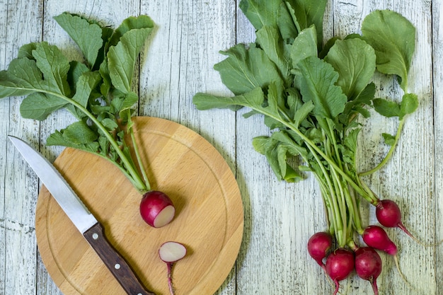 Premium Photo | Fresh ripe radish cut into pieces on a cutting board ...