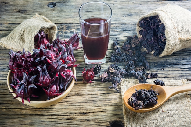 Premium Photo | Fresh roselle, roselle dried and roselle juice on a ...