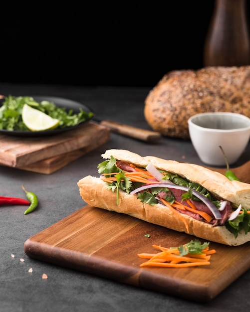 Premium Photo | Fresh sandwich on chopping board with carrots