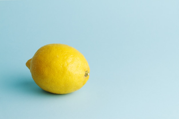 Premium Photo | Fresh whole lemon on blue background