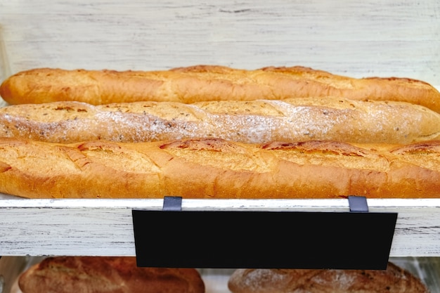 Download Free Freshly Baked Gluten Free Baguette Breads On White Wooden Shelves Use our free logo maker to create a logo and build your brand. Put your logo on business cards, promotional products, or your website for brand visibility.