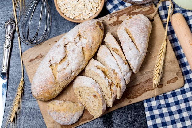 Freshly baked traditional bread on wooden table Oatmeal Bread Free Photo