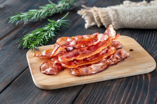 Premium Photo | Fried bacon on the cutting board, rustic background