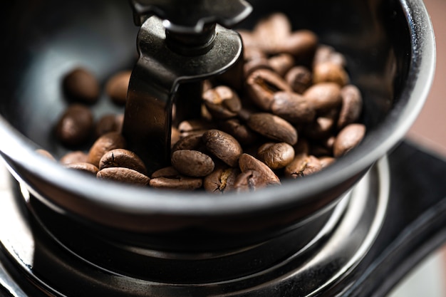 Premium Photo | The fried coffee beans lie in a coffee grinder. arab ...