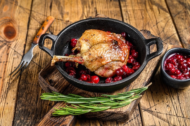 Premium Photo | Fried duck leg with cranberrie sauce in a pan