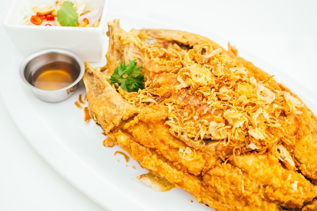 Premium Photo | Fried sea bass meat fish with sauce