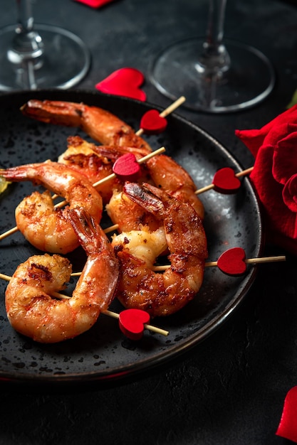 Premium Photo | Fried shrimp, roses and champagne. original appetizer ...