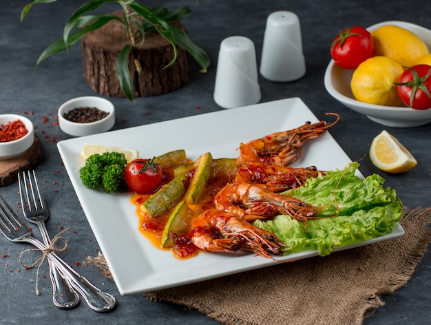 Fried shrimps with vegetables on the table Free Photo
