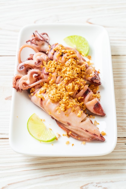 Premium Photo | Fried squid with garlic