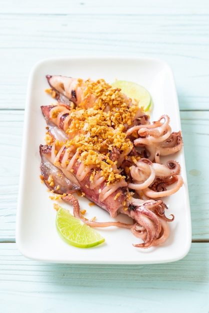 Premium Photo | Fried squid with garlic
