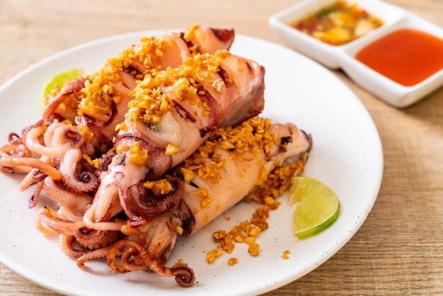 Premium Photo | Fried squid with garlic