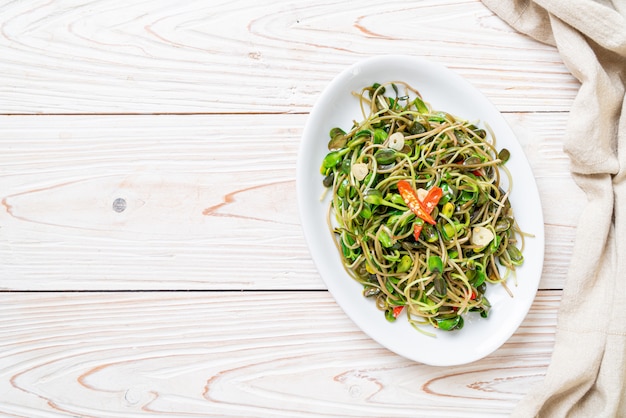 Premium Photo | Fried sunflower sprout with oyster sauce