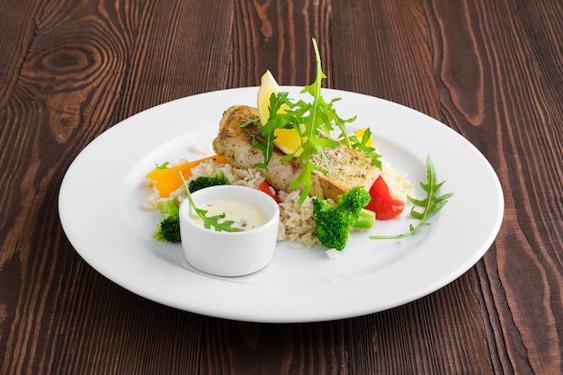Fried Zander With Rice Bell Pepper And Arugula Served With