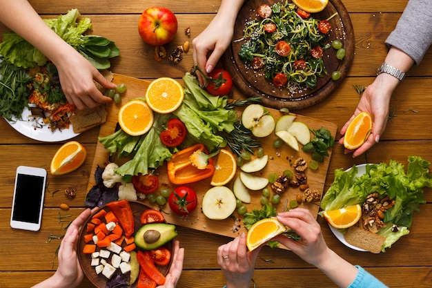 Premium Photo | Friends eat healthy food together. vegan dinner table ...
