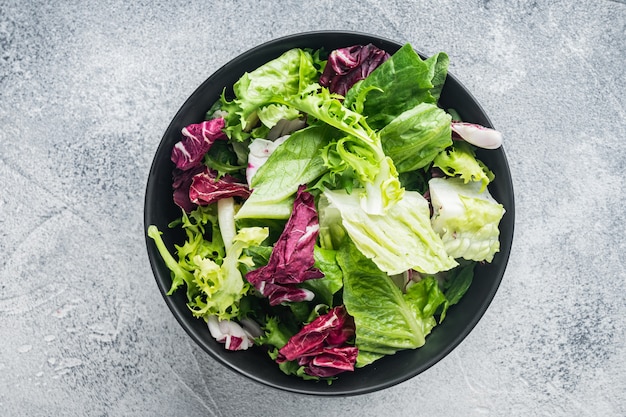 Premium Photo | Frieze, romaine and radicchio lettuce salad, on gray ...