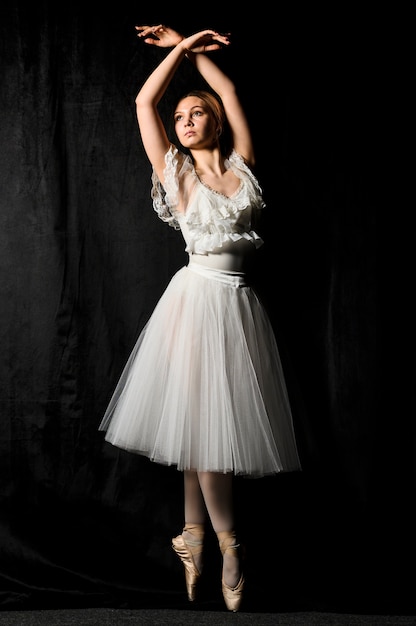 Download Front view of ballerina posing in pointe shoes and tutu ...