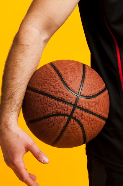 Download Front view of basketball held by man close to hip | Free Photo
