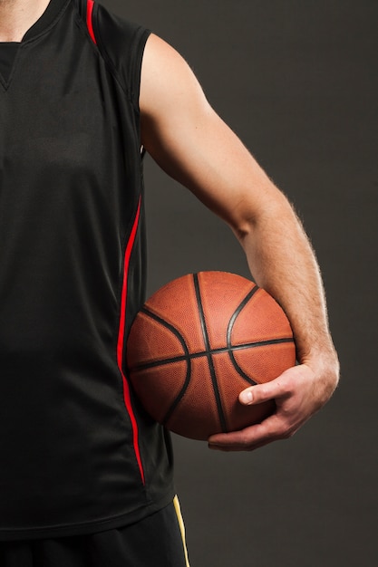 Download Front view of basketball held by player close to body ...