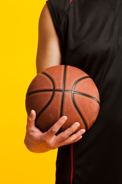 Premium Photo Front View Of Basketball Held In One Hand By Male Player