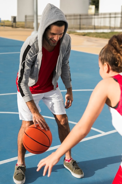 Free Photo | Front view of boy and girl playing basketball