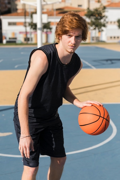 Download Front view of boy playing basketball | Free Photo