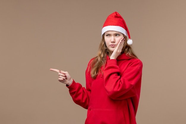 Free Photo | Front view christmas girl with confused face on brown ...