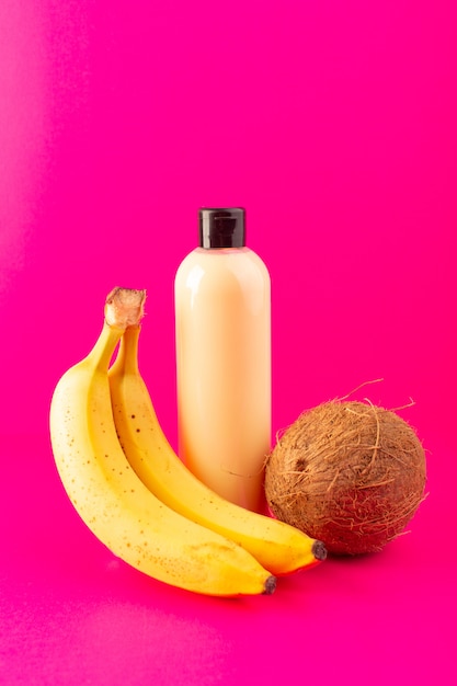 Download A front view cream colored bottle plastic shampoo can with black cap isolated along with bananas ...