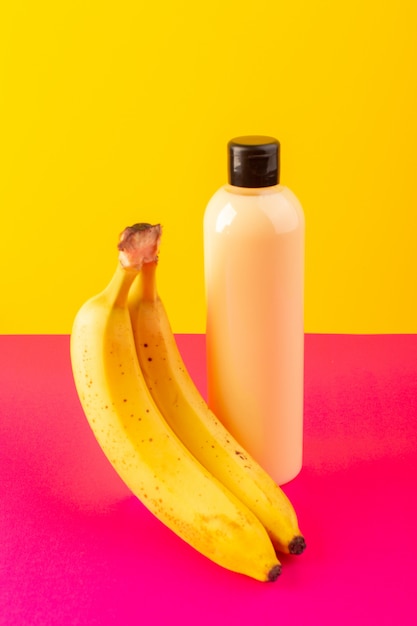 Download A front view cream colored bottle plastic shampoo can with black cap isolated along with bananas ...