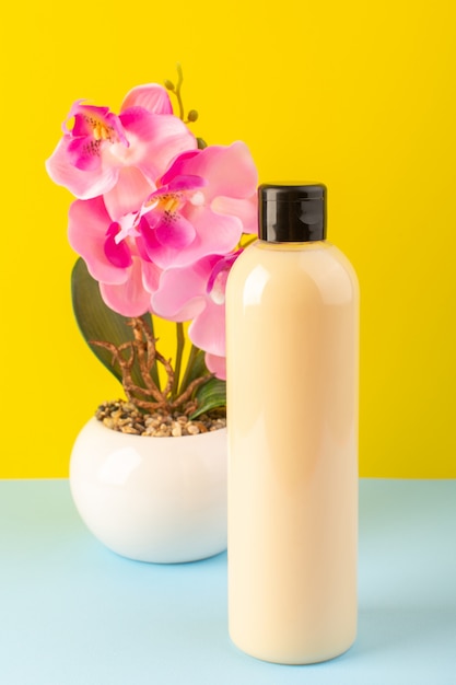 Download Free Photo A Front View Cream Colored Bottle Plastic Shampoo Can With Black Cap Isolated Along With Flowers On The Yellow Iced Blue Background Cosmetics Beauty Hair PSD Mockup Templates
