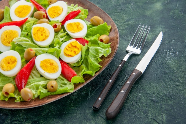 Front view delicious egg salad with green salad and olives on dark blue background Free Photo