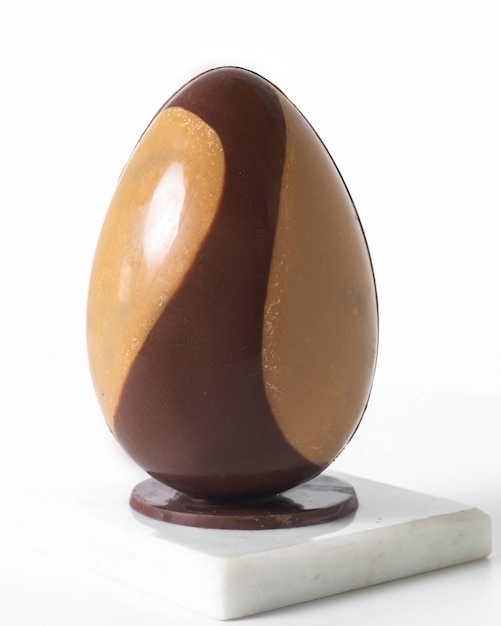 Download Front view egg two-colored brown and dark choco on the white floor | Free Photo