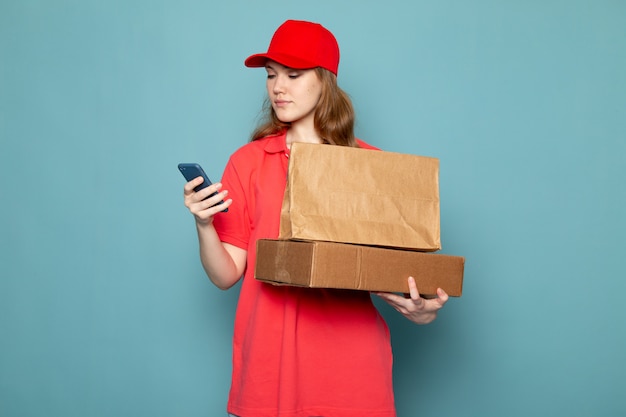 A front view female attractive courier in red polo shirt ...