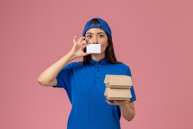 Download Free Photo | Front view female courier in blue uniform cape holding card and little delivery ...