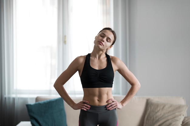 Free Photo | Front view of female stretching her shoulders before ...