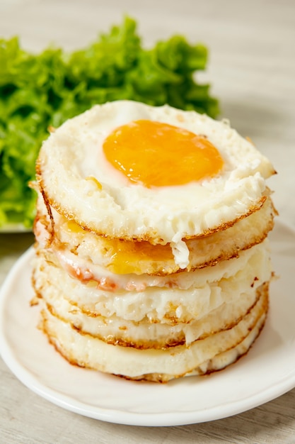 Download Free Photo | Front view fried eggs arrangement on plain background