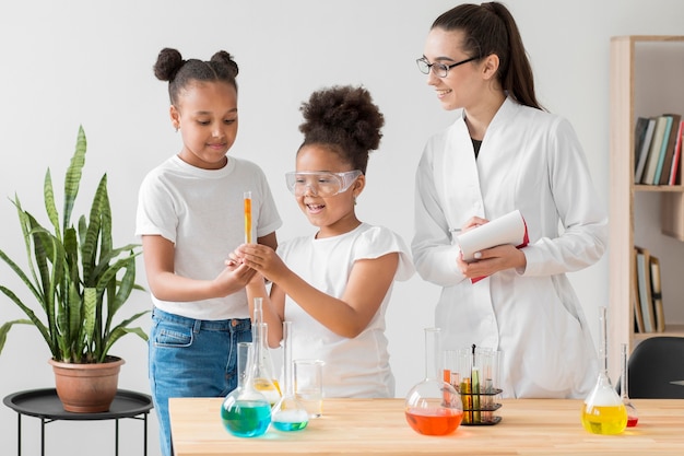 Free Photo | Front view of girls enjoying a chemistry experiment with ...