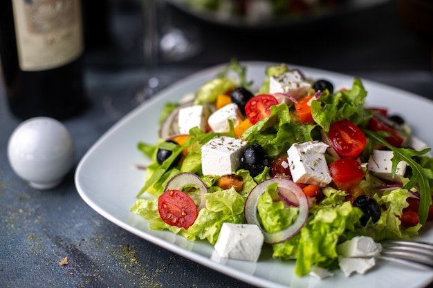 A front view greece salad sliced vegetable salad with tomatoes cucumbers white cheese and olives inside white plate vitamine vegetables Free Photo