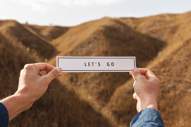 Front view hands holding sign with mock-up Free Photo