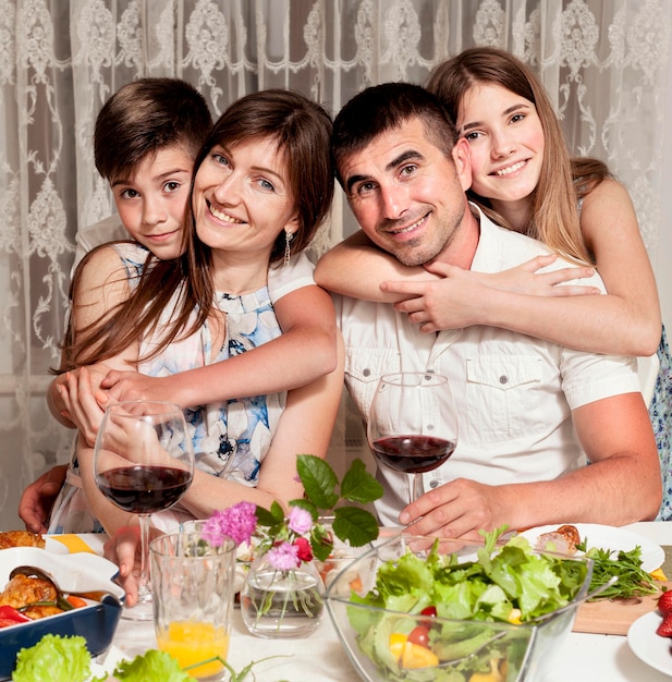 front-view-happy-family-dinner-table-with-wine_23-2148610954.jpg